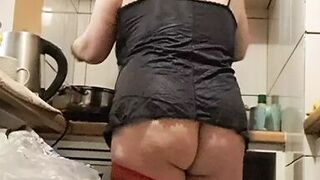Wife in kitchen teasing husband to have sex while he watches - 1 image