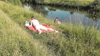Wild beach. Sexy MILF Platinum naked sunbathing on river bank, random fisherman guy watches. Naked in public. Nude beach