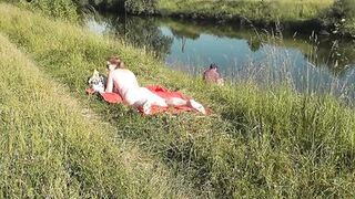 Wild beach. Sexy MILF Platinum naked sunbathing on river bank, random fisherman guy watches. Naked in public. Nude beach