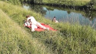 Wild beach. Sexy MILF Platinum naked sunbathing on river bank, random fisherman guy watches. Naked in public. Nude beach