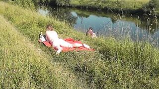 Wild beach. Sexy MILF Platinum naked sunbathing on river bank, random fisherman guy watches. Naked in public. Nude beach