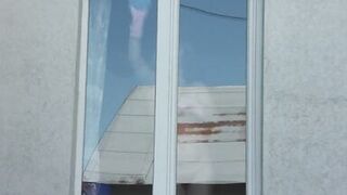 Neighbor taxi driver from window car again looks at neighbor MILF who washes window of apartment naked. Nude in public - 2 image