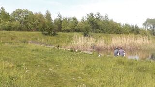 Wild beach. Naked in public. Two fisherman guys saw beautiful MILF on shore of lake, who sunbathes nude, masturbates wet pussy, gets strong orgasm. Masturbation in public. Outdoors. Outside. Nudist beach Naturists - 4 image