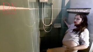 Nice lady in the shower in wet clothes and a hat. Striptease dancing in the shower. 1