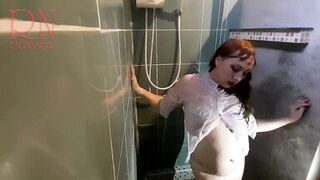 Nice lady in the shower in wet clothes and a hat. Striptease dancing in the shower. 1