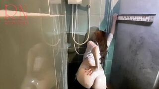 Nice lady in the shower in wet clothes and a hat. Striptease dancing in the shower. 1